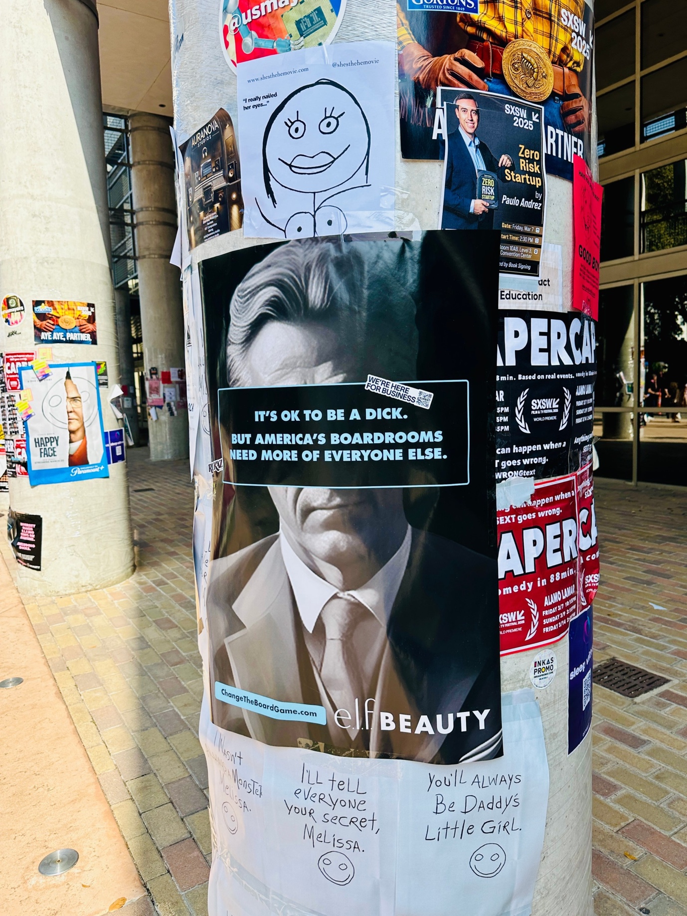 A pole with posters on it</p>
<p>Description automatically generated
